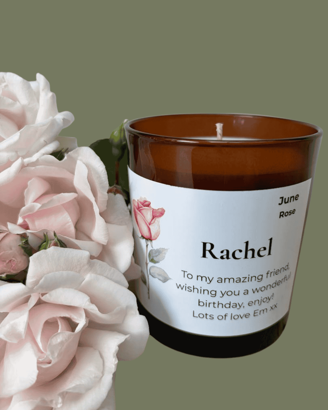 Birthday Candle with a personalised message next to pink roses on a green background