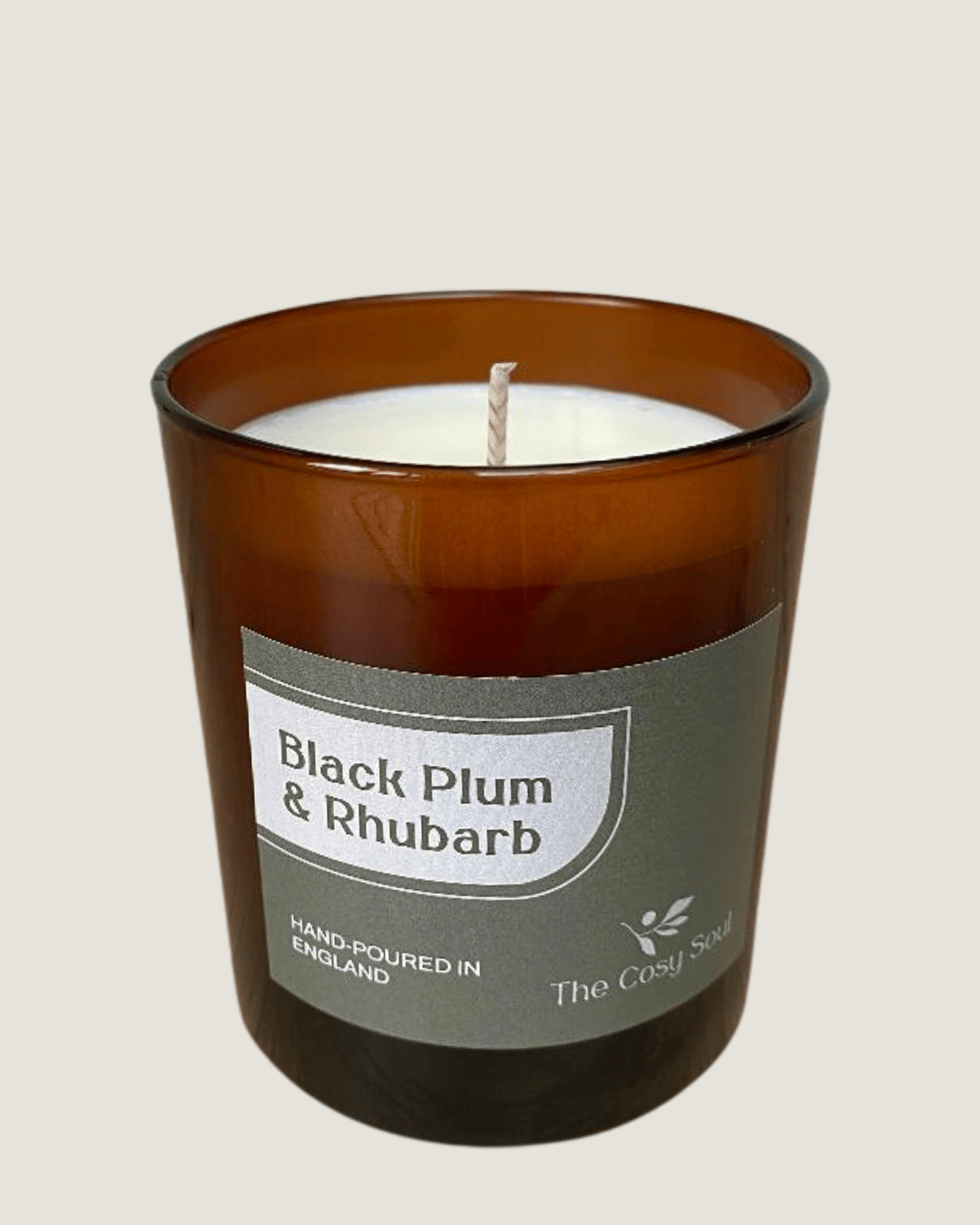 The Cosy Soul Black Plum and Rhubarb candle on a grey background