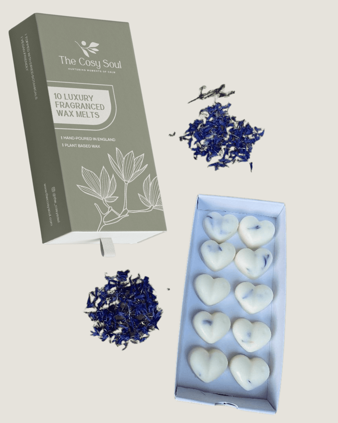 Heart-shaped coastal calm fragranced wax melts in a box with packaging and dried blue flowers.