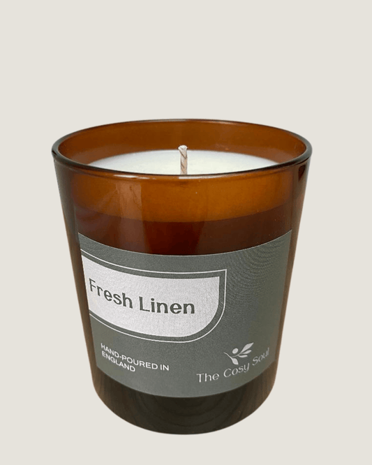 The Cosy Soul Fresh Linen Candle in an amber jar
