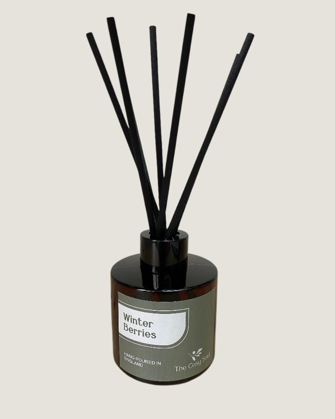 The Cosy Soul reed diffuser with black reeds labelled 'Winter Berries' on a light grey background